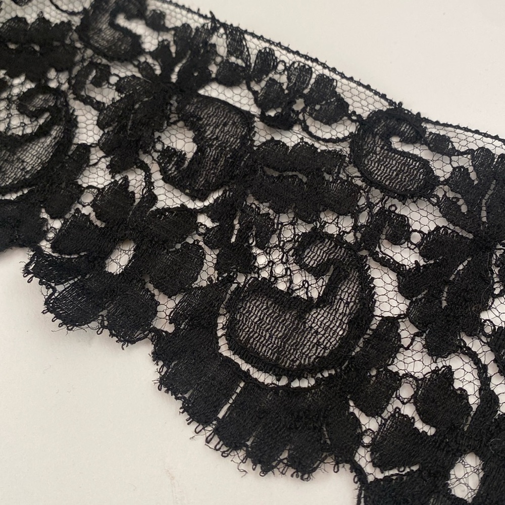 3” (11 yards) BLACK LACE w/ straight edge on one side & scallops on the border.